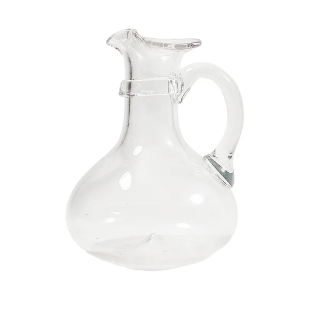 Front view of Pienza glass pitcher showcasing bulbous base, flared spout, and curved handle on a white background