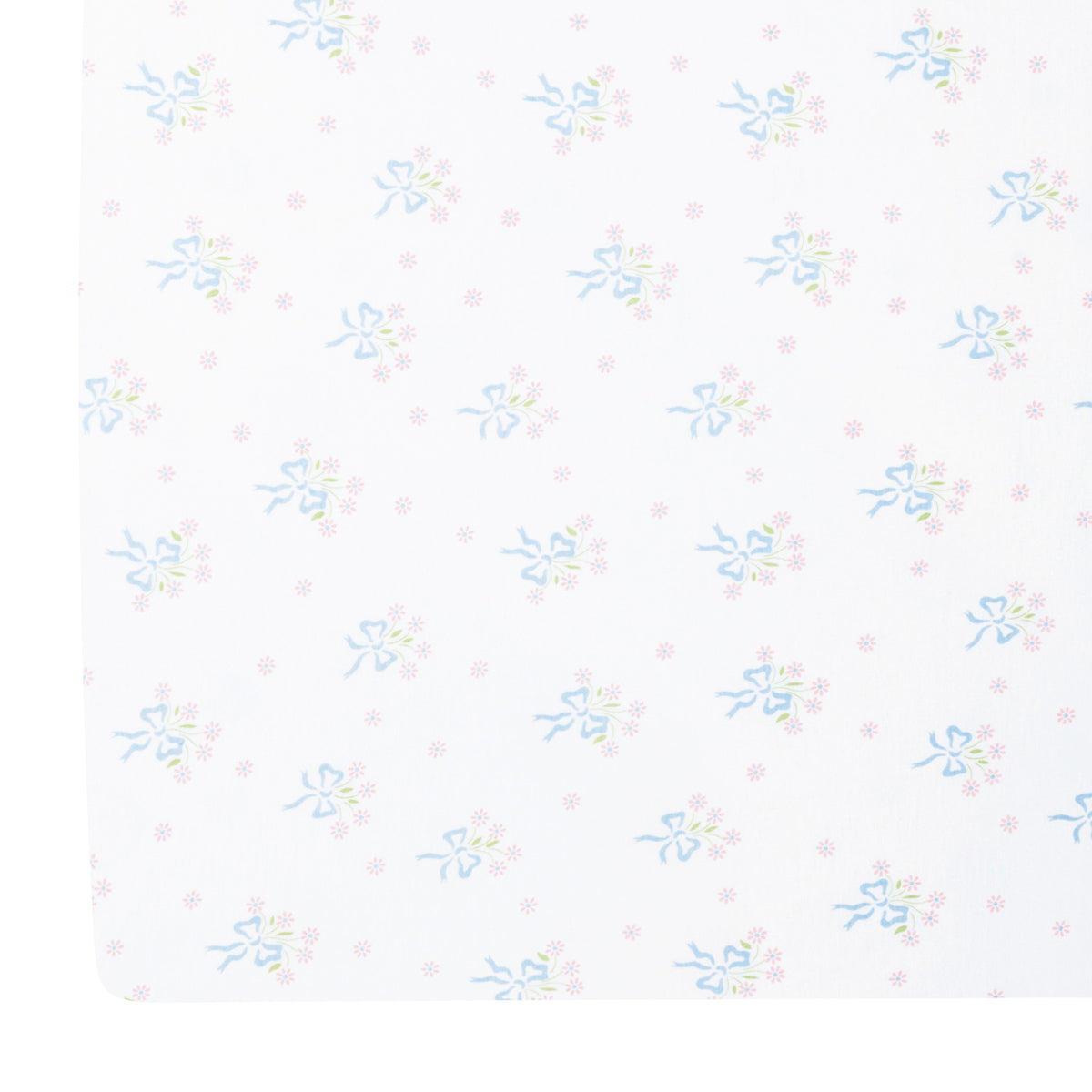 Top-down view of Pima crib sheet showing blue bow-tied pink floral bouquet all-over print on white background