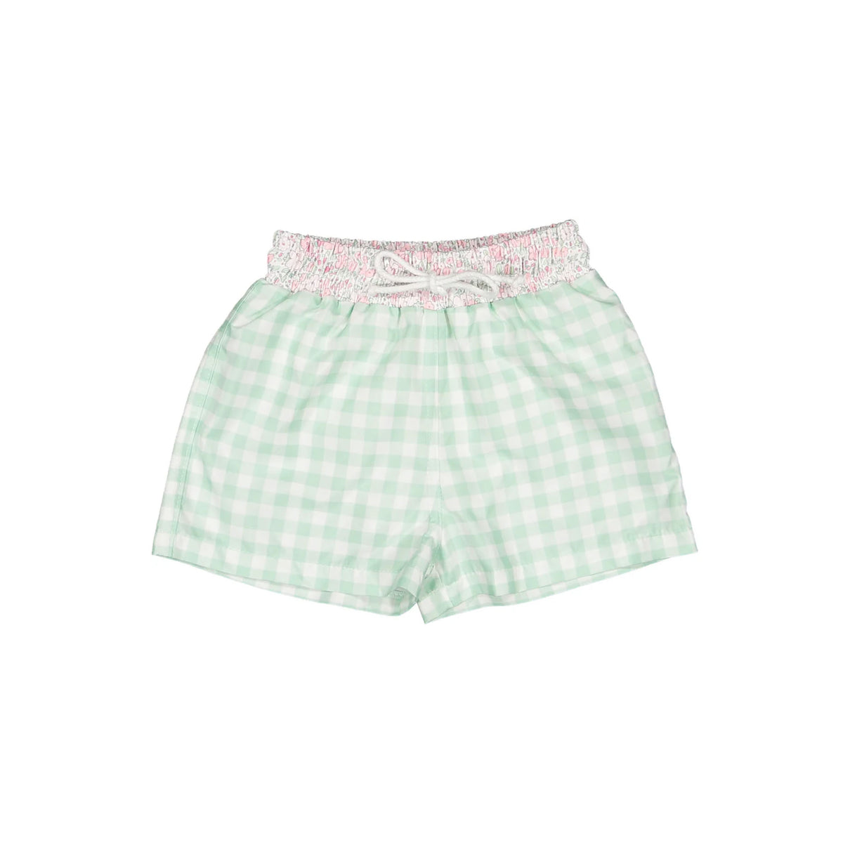 Flat lay of children’s trunks with smocked pink ditsy floral waistband and mint gingham shorts on white background