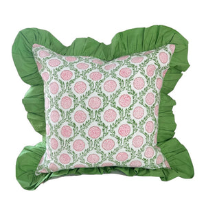 Decorative pillow with pink floral pattern and green ruffled edges on a white background