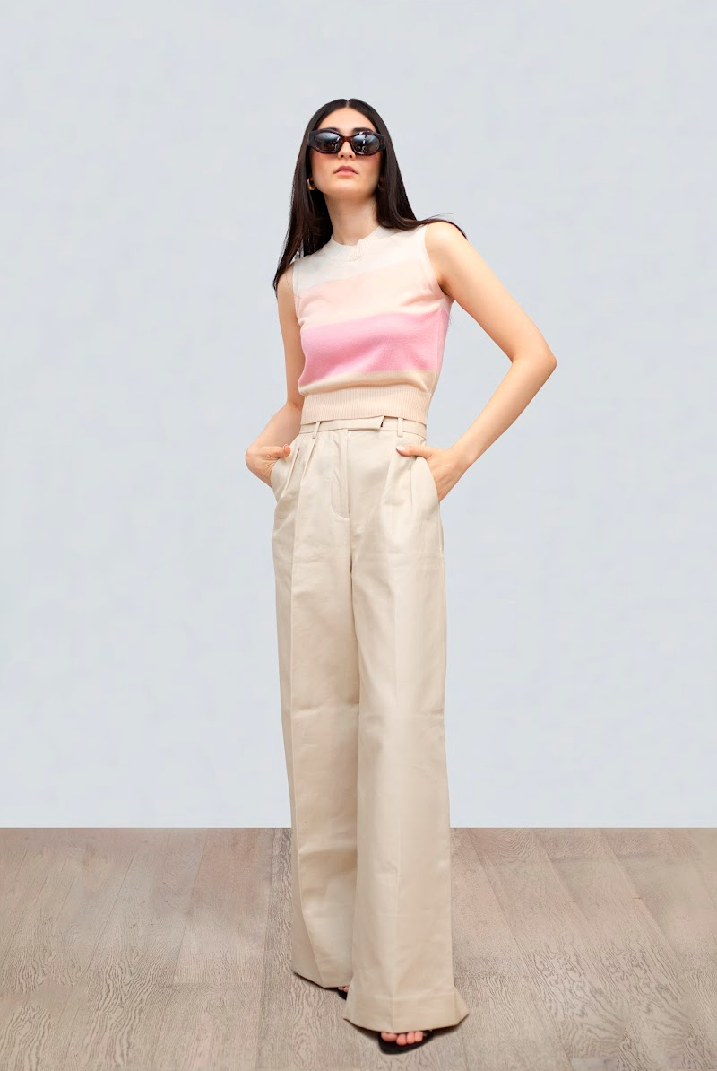 Front view of Crewneck Tank Pink Stripe showcasing its sleeveless crewneck and pink stripe on a model against a light gray studio background