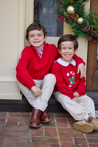 Little English traditional children's clothing. Red Intarsia Sweater with candy cane motif for boys and girls layered over red piped white knit peter pan shirt and khaki pebble twill banded pants. Older boys red quarter zip sweater and red gingham button down shirt and khaki pebble twill classic pants.