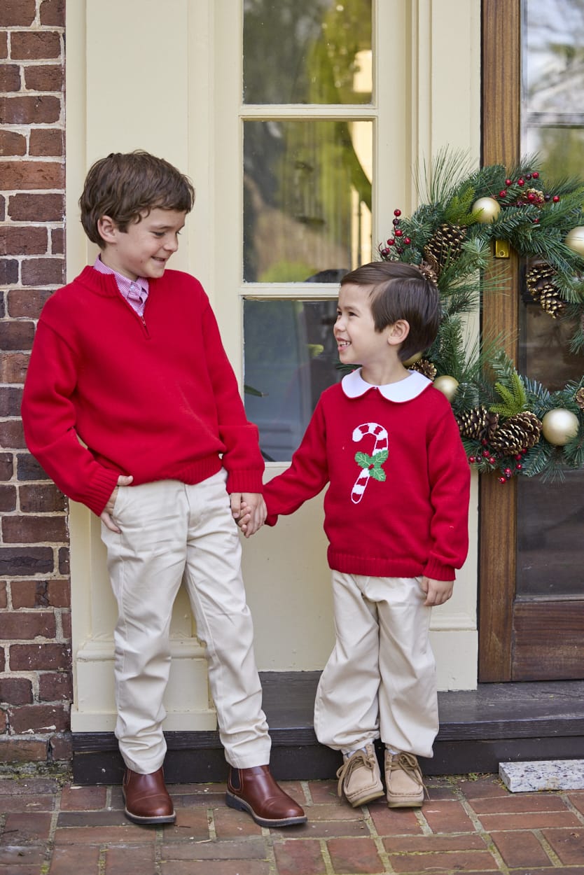 Little English traditional children's clothing. Red Intarsia Sweater with candy cane motif for boys and girls layered over red piped white knit peter pan shirt and khaki pebble twill banded pants. Older boys red quarter zip sweater and red gingham button down shirt and khaki pebble twill classic pants.