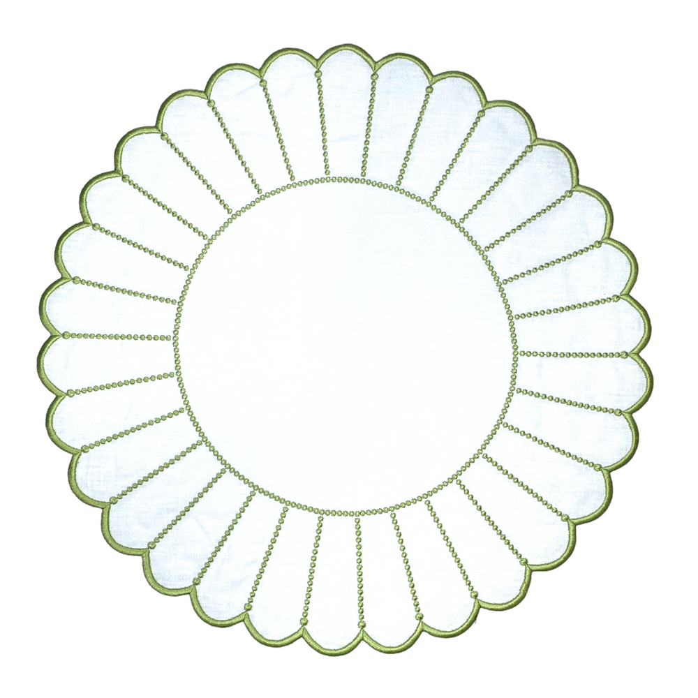 Overhead view of Pippa placemat in white and green showcasing scalloped silk embroidery on a white background