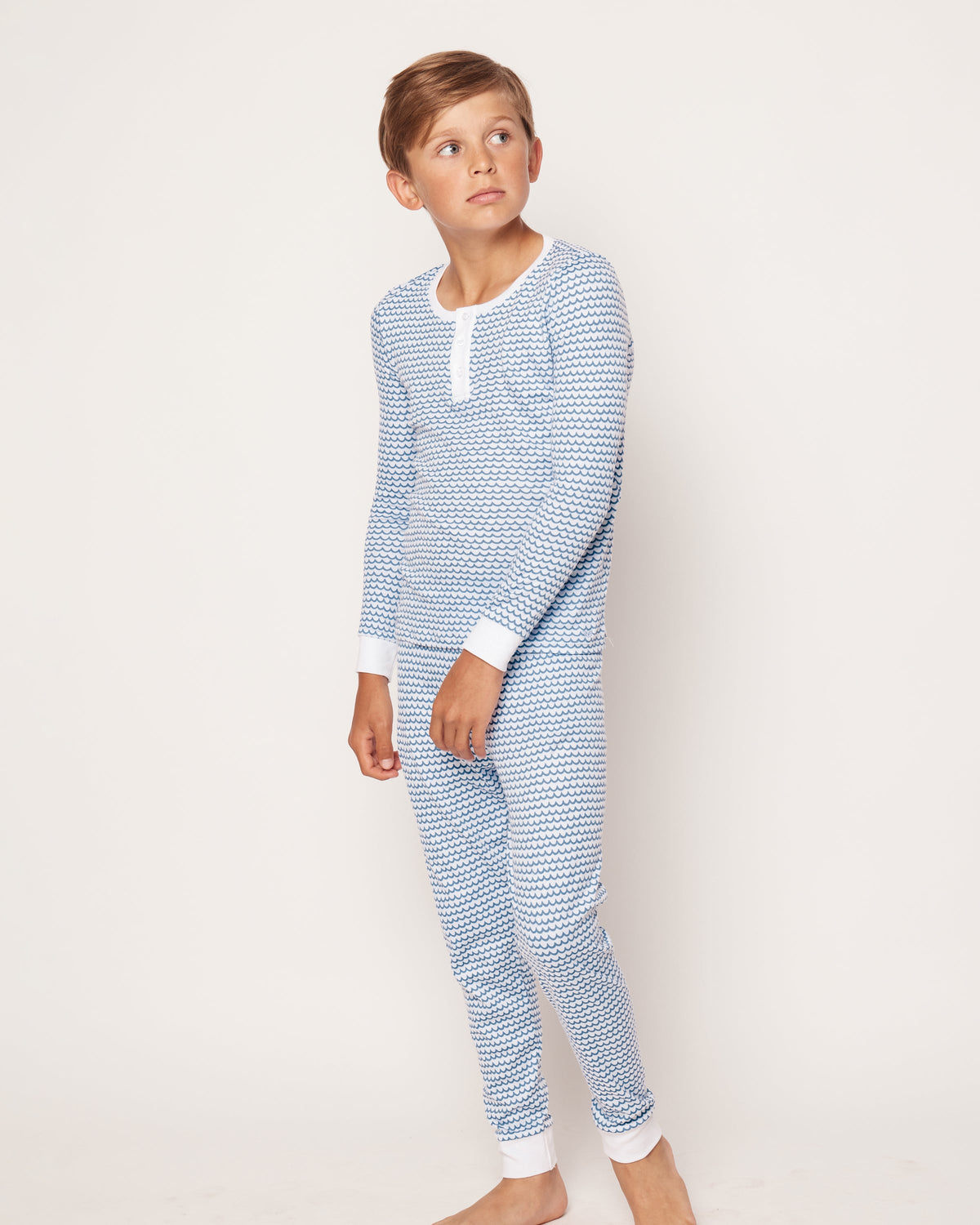 Side view of Kid’s Pima Snug Fit Pajama Set in La Mer showcasing blue wave pattern and white trim with white background