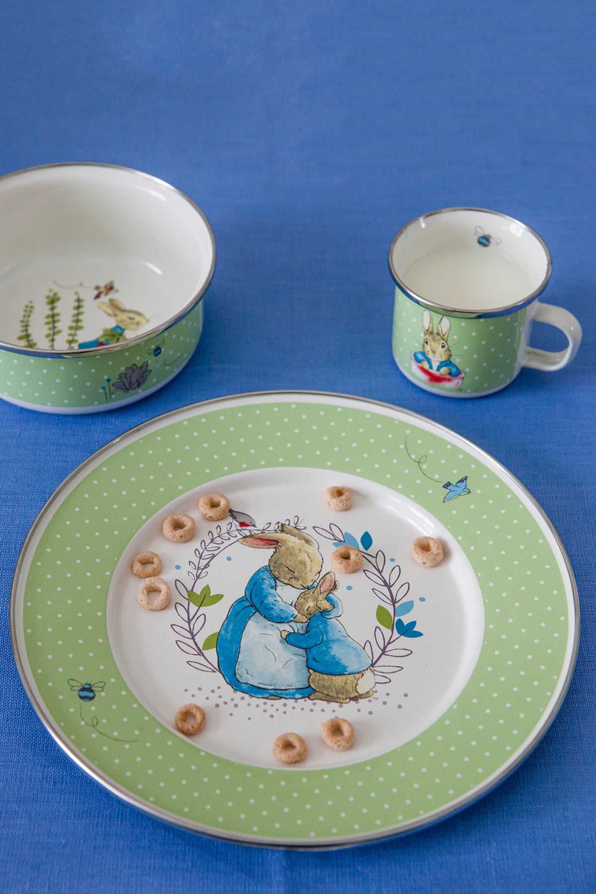 Close-up of Child Set in Polka Dot Peter showcasing green polka dots and Peter Rabbit illustrations on blue fabric