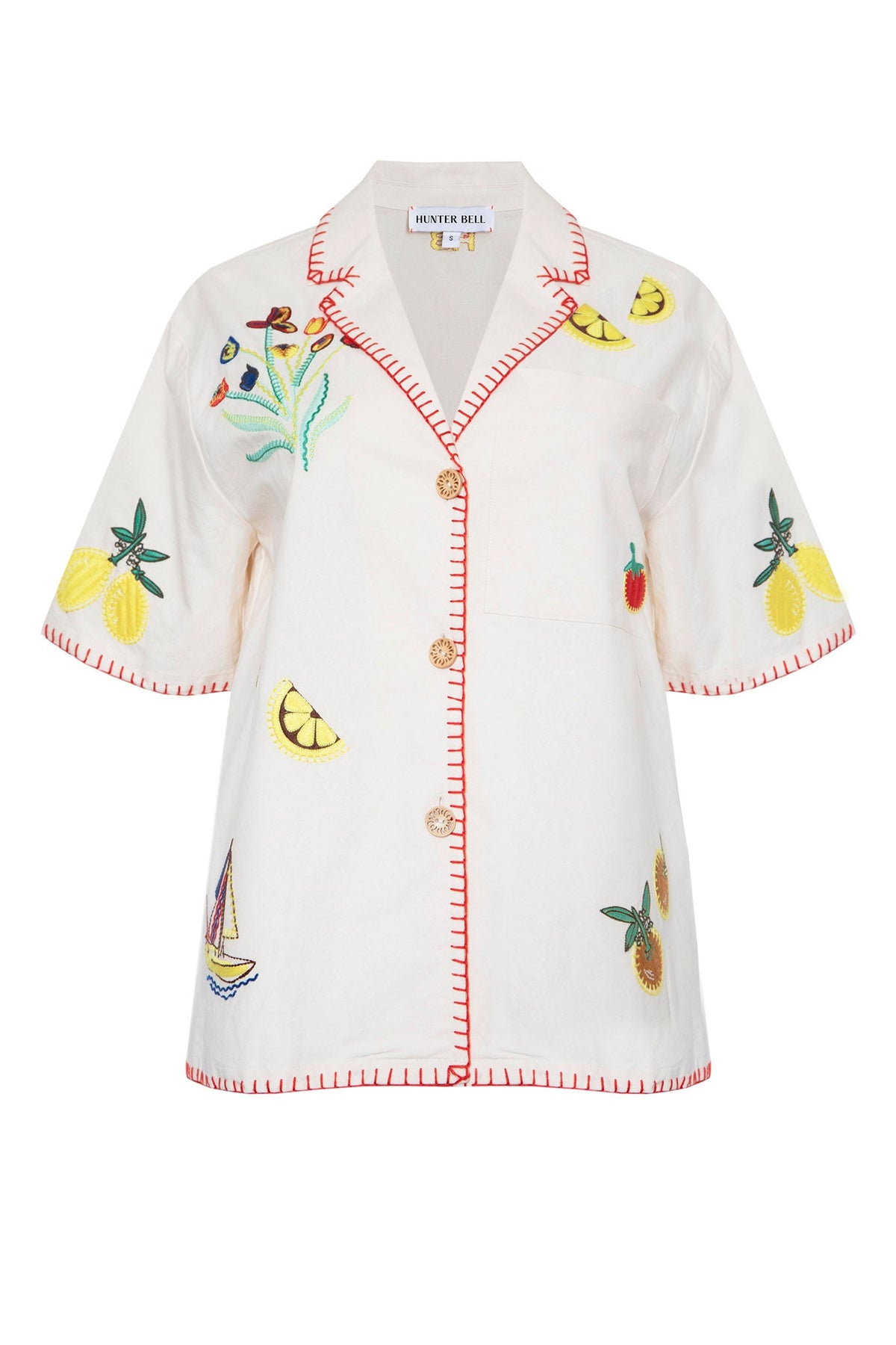 The Polly shirt is a collared short sleeve embroidered camp shirt with whipstich detailing. 