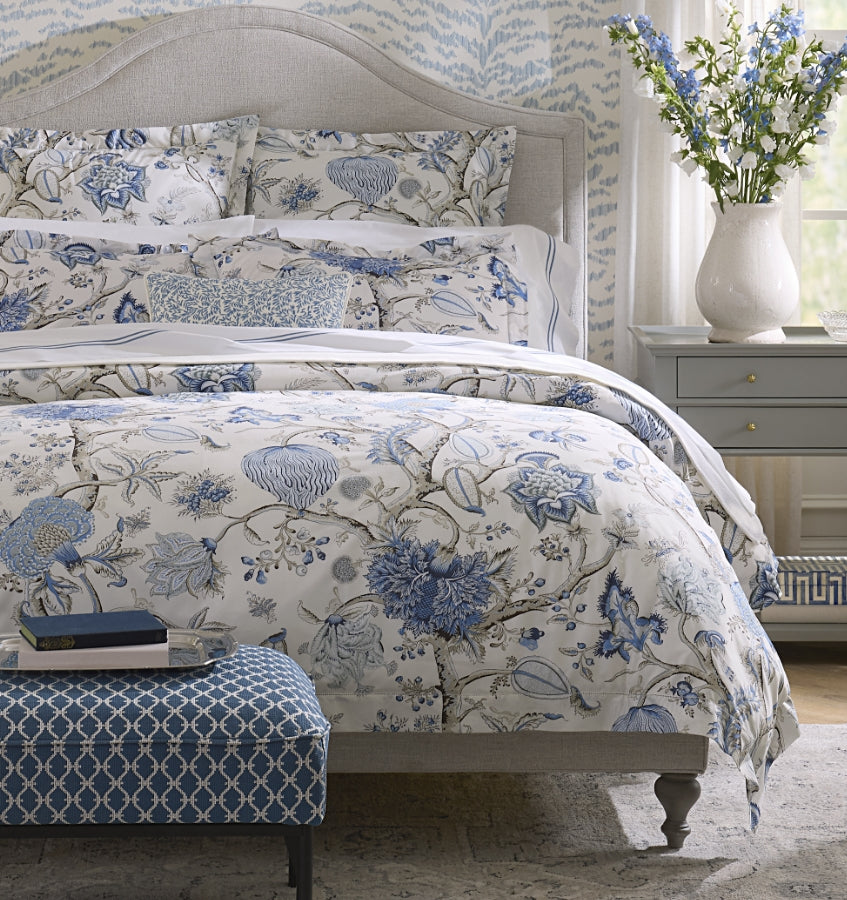 Front view of Pondicherry Duvet Cover in Sea showcasing blue floral Palampore print on white percale with neutral headboard