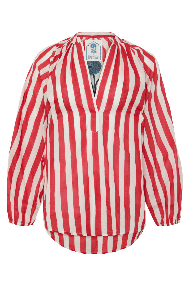 Front view of the Porto Popover in red cabana stripes showcasing its deep split neck and gathered cuffs on white
