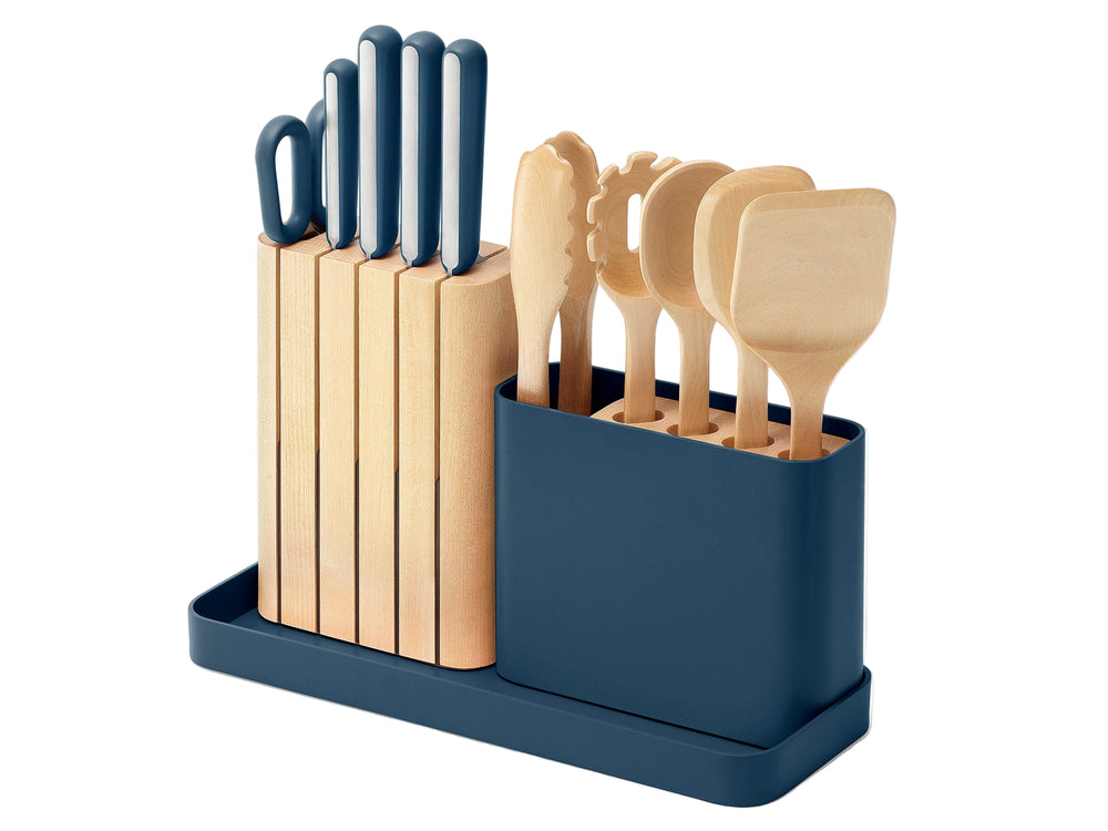 Three-quarter view of knife and utensil set in navy storage with wooden knife block and blue-handled knives and utensils