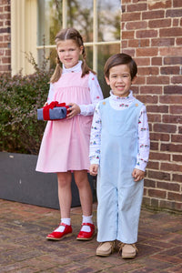Little English classic children's clothing. White knit turtleneck with holiday train print layered under light blue corduroy Campbell Overall. White knit turtleneck with holiday present print layered under light pink corduroy Madison Jumper. Holiday outfit for little boys and girls.
