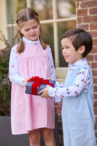 Little English classic children's clothing. White knit turtleneck with holiday train print layered under light blue corduroy Campbell Overall. White knit turtleneck with holiday present print layered under light pink corduroy Madison Jumper. Holiday outfit for little boys and girls.
