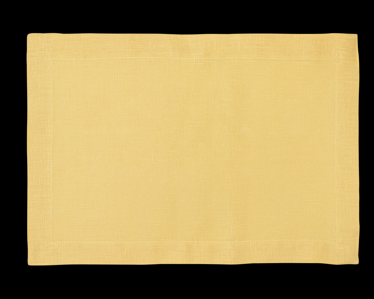 A linen placemat in the color butter