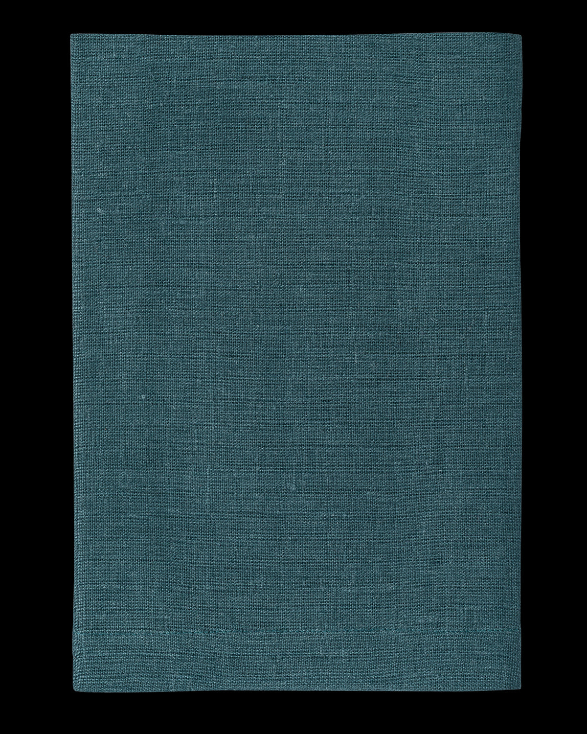 A linen placemat in the color peacock