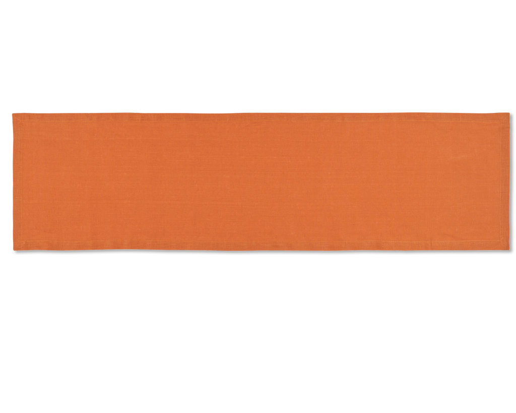 A linen table runner in the color tangerine