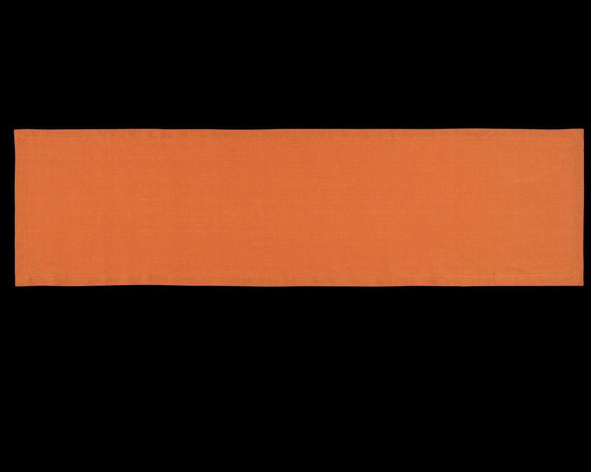 A linen table runner in the color tangerine