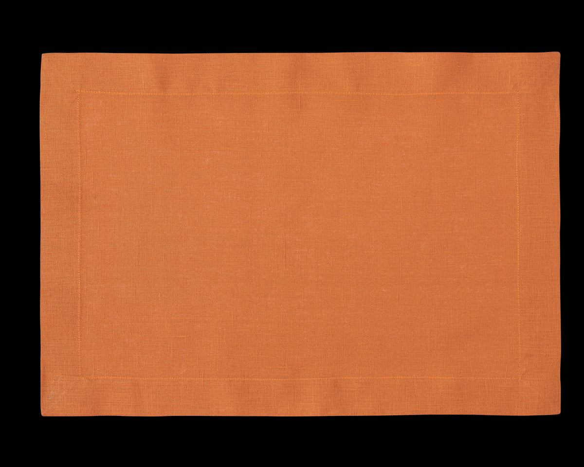 A linen placemat in the color tangerine