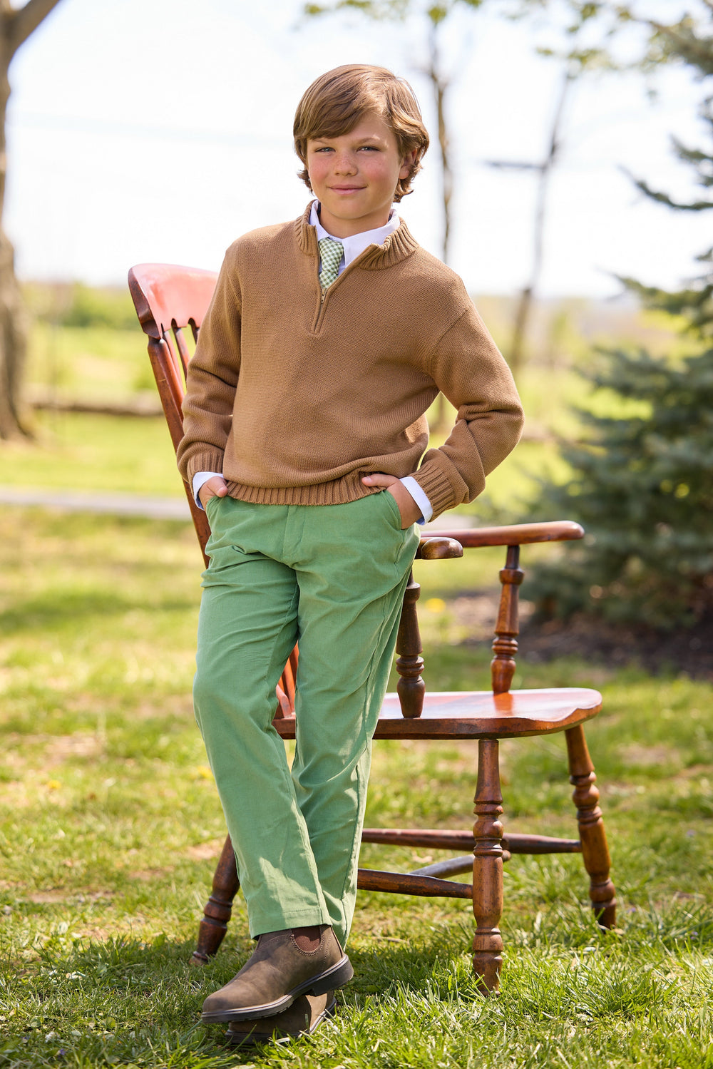 Front view of Classic Pant in Watercress Corduroy showcasing reinforced knees and tailored fit on a boy outdoors
