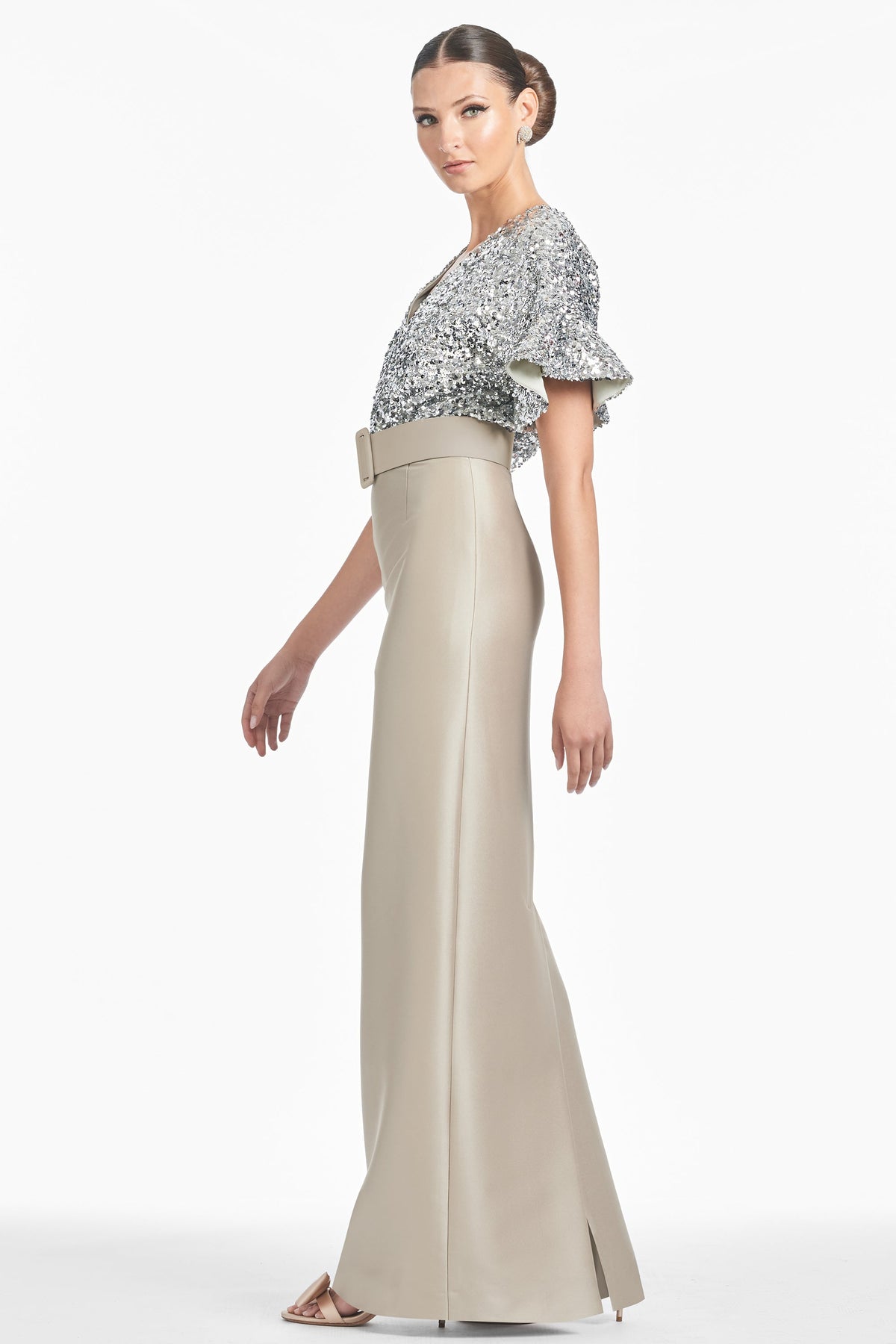 Three-quarter view of Marlene Gown in Silver/Pewter with metallic sequin drop sleeves and self-belt on white background