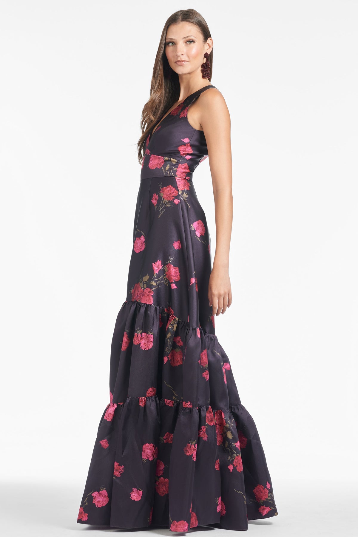 Three-quarter view of the Rori Gown in Malbec Tea Blooms showing its floral print and cinched waist on a model against white
