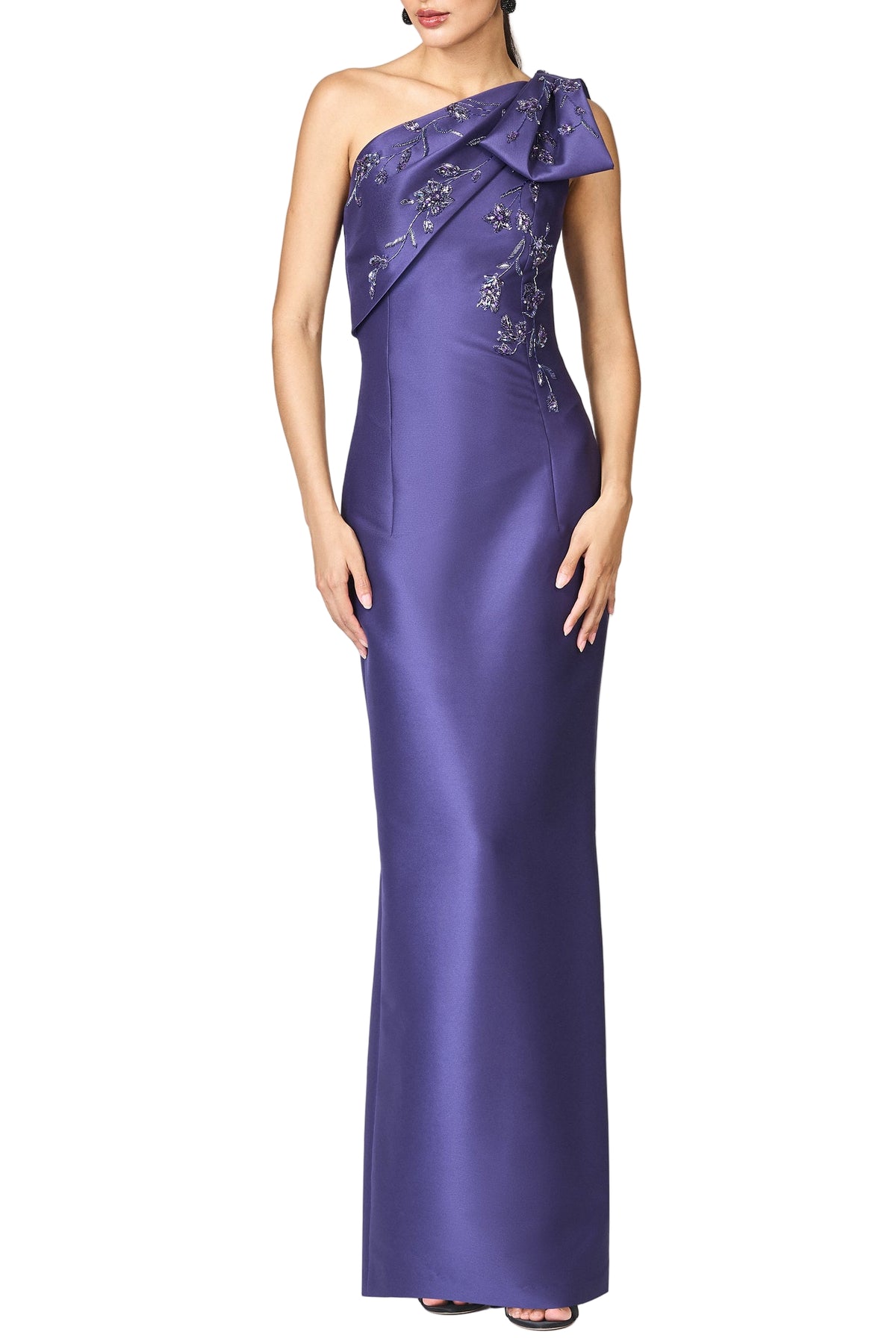 Front view of Embellished Olivia gown in concord on model showcasing one-shoulder sculptural bow and tonal floral embroidery on white background