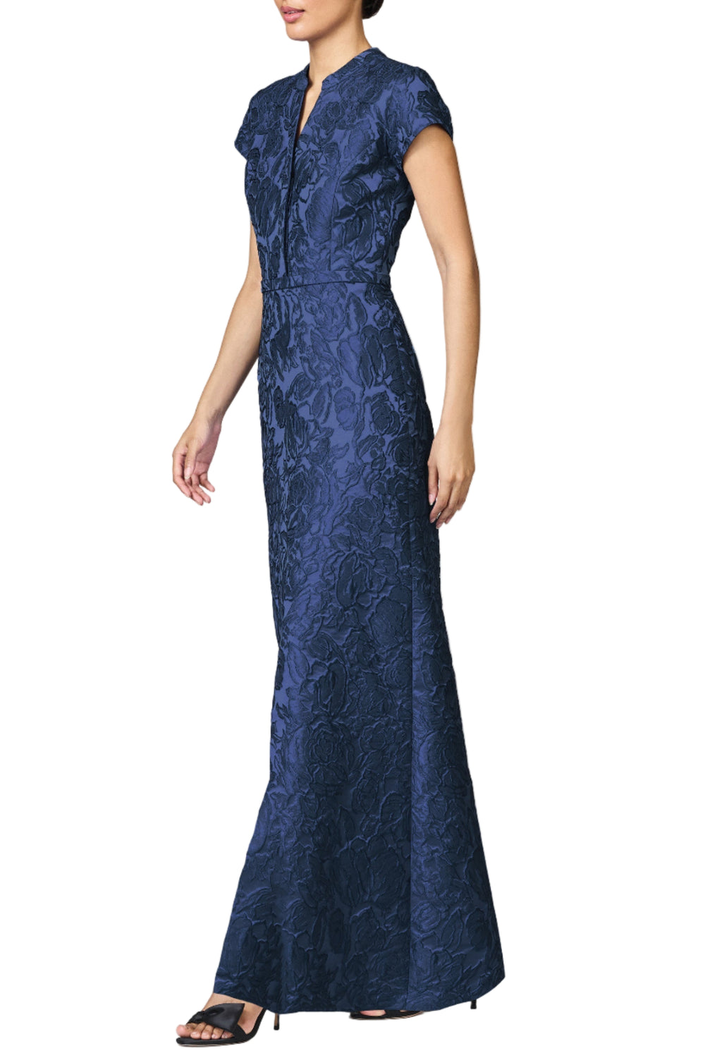 Side view of Cloqué Justine gown in midnight on model, fitted full-length with textured floral fabric and cap sleeves