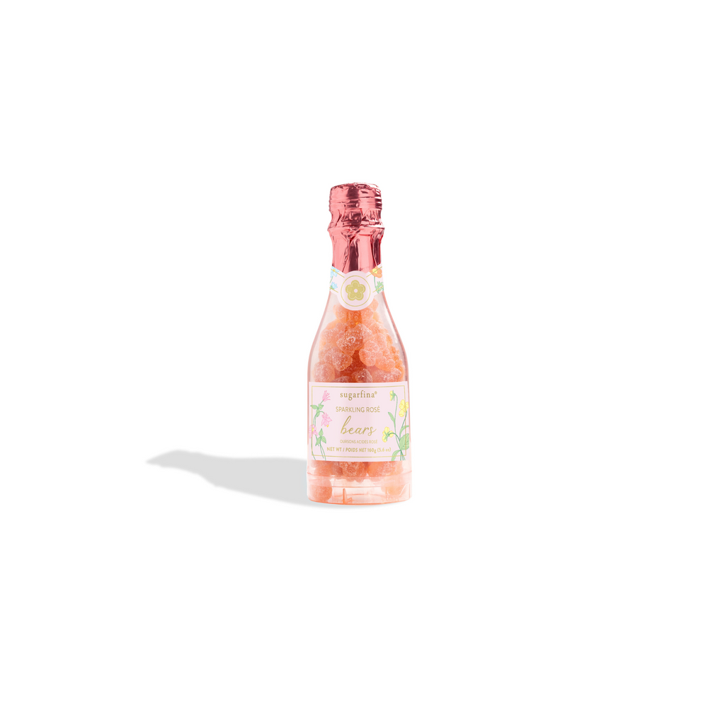 Front view of Sugarfina La Vie En Rose sparkling rosé gummy bears in a clear bottle-shaped container with pink foil top on white background
