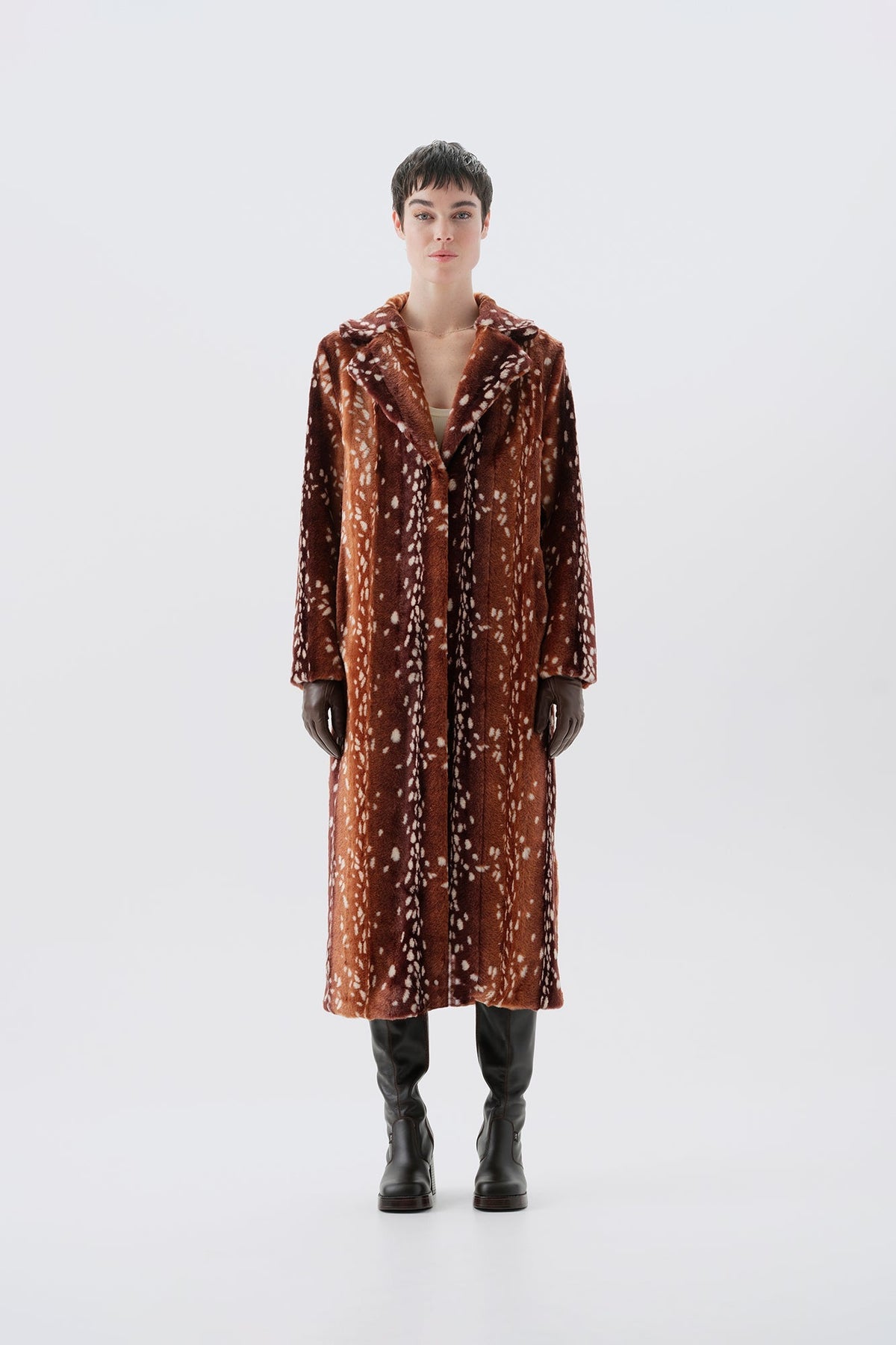 Model pictured from the back wearing a long brown faux fur coat with a bambi pattern