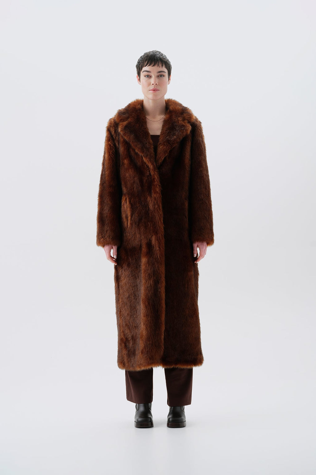 Model wearing a warm and long brown faux fur coat