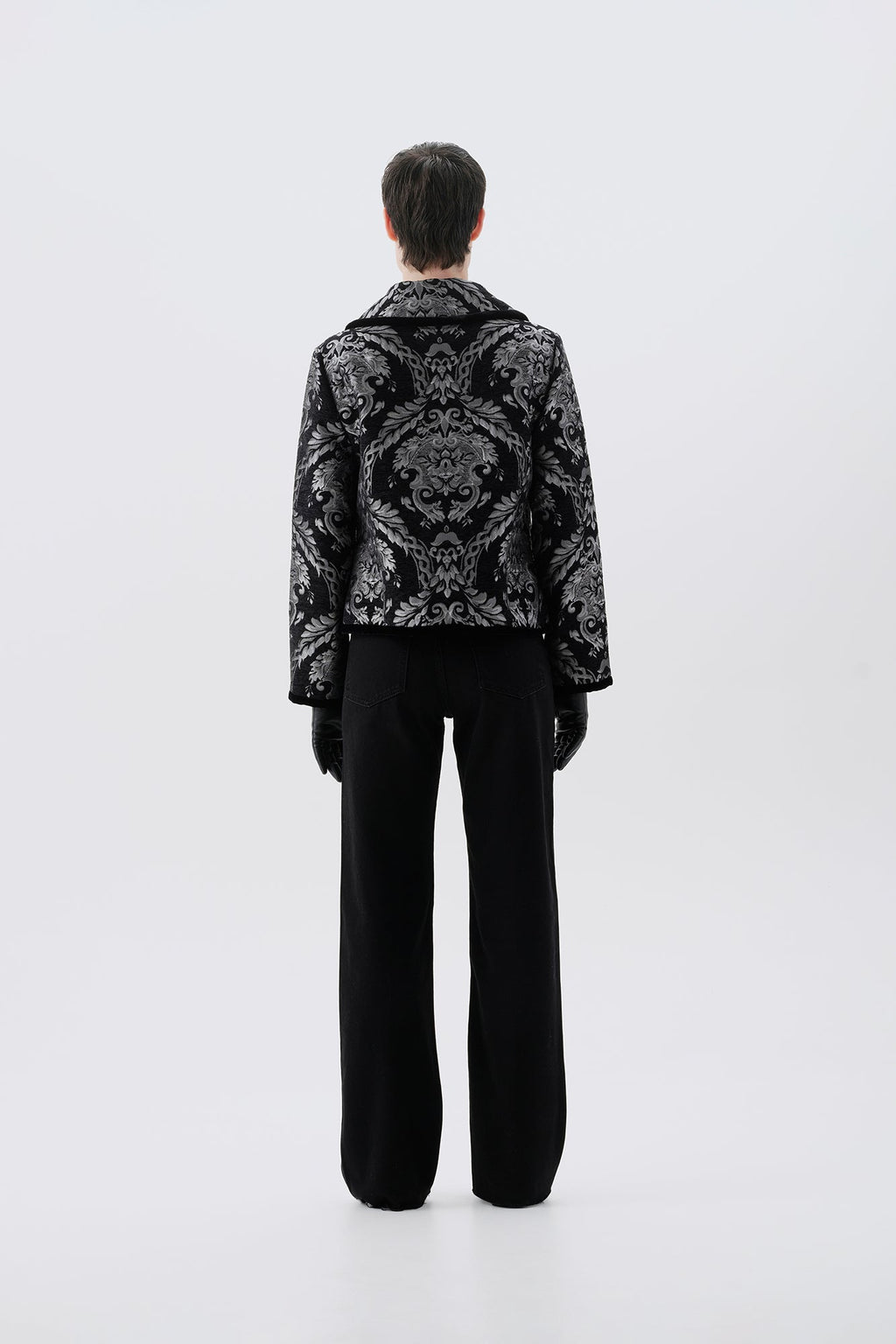 Black and silver patterned jacket, back view, paired with black pants