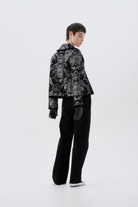 Black and silver patterned jacket, side view, paired with black pants
