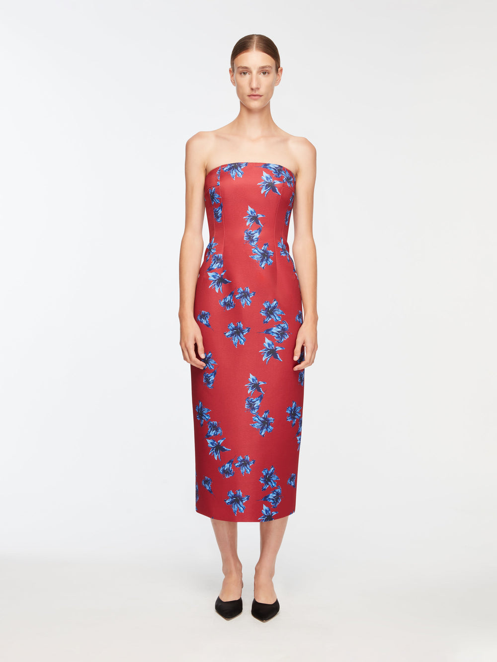 Front view of Leila strapless red taffeta faille midi dress with blue lilies, fitted column silhouette on model against white background