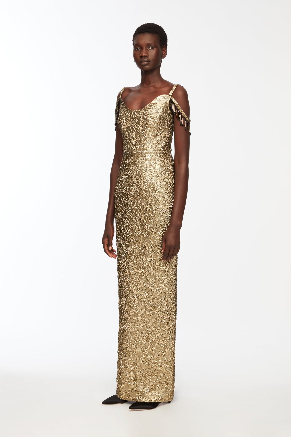 Full-length front view of Morphita gold floral dress with textured fabric, scoop neckline and embellished shoulder fringe