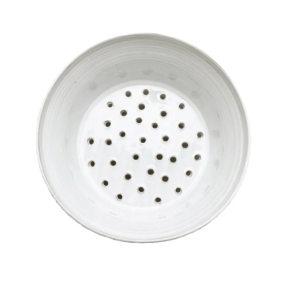 Top view of Radi Fluted Colander showcasing its perforated base and softly fluted stoneware body on a white background