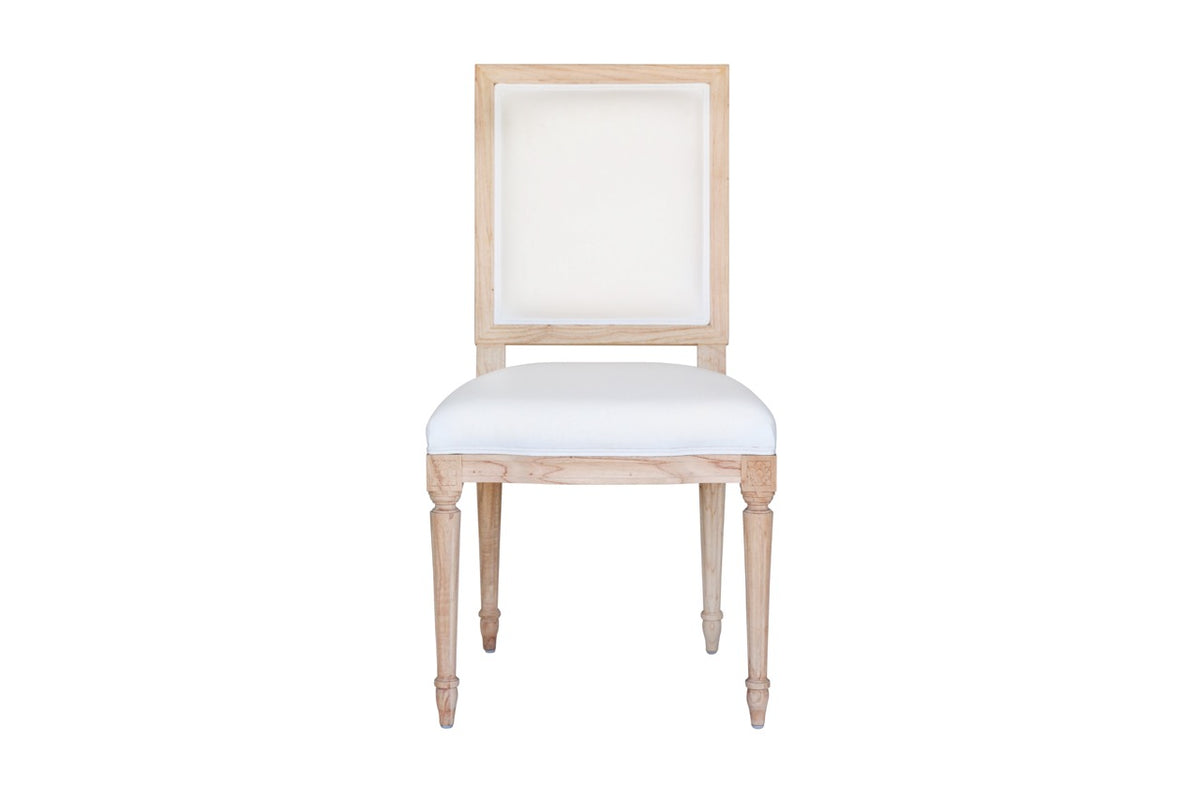 Front view of Bienville Chair showcasing white Libeco linen upholstery and light oak carved wood frame on white background