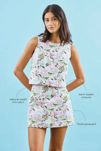 The Britt Mini Skirt in Magnolia Grove Jacquard paired with the Rebecca Top with blue background with call outs.