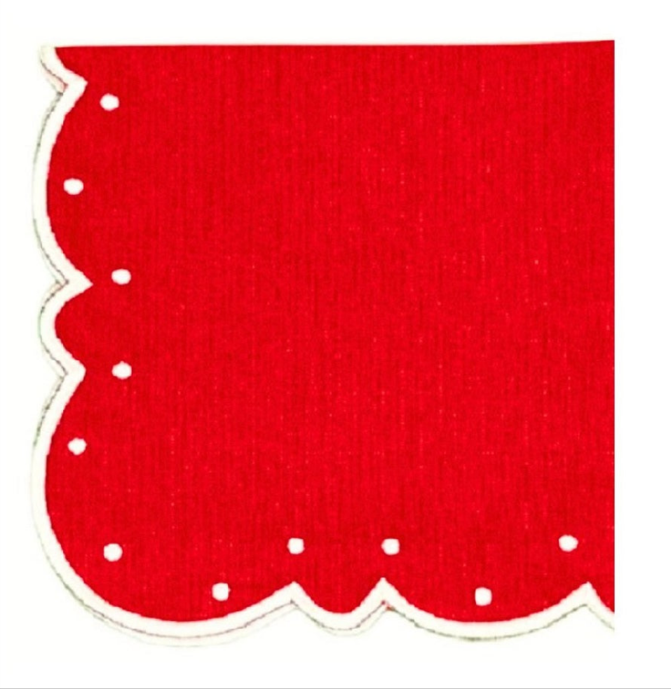 A red napkin with white embroidery and a scalloped edge design.