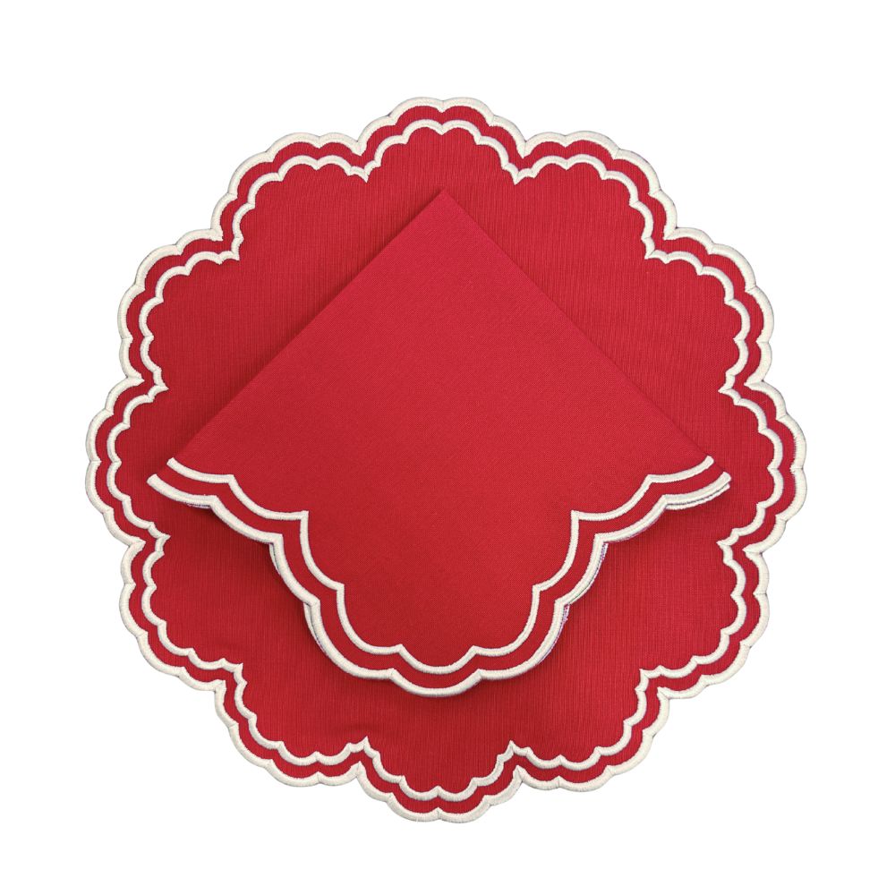 Red scalloped placemat with white embroidery and matching napkin
