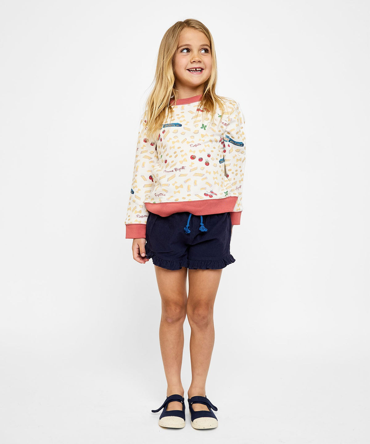 Front view of cream Remy Sweatshirt in Basta Pasta with pasta and tomato print on child model against white background