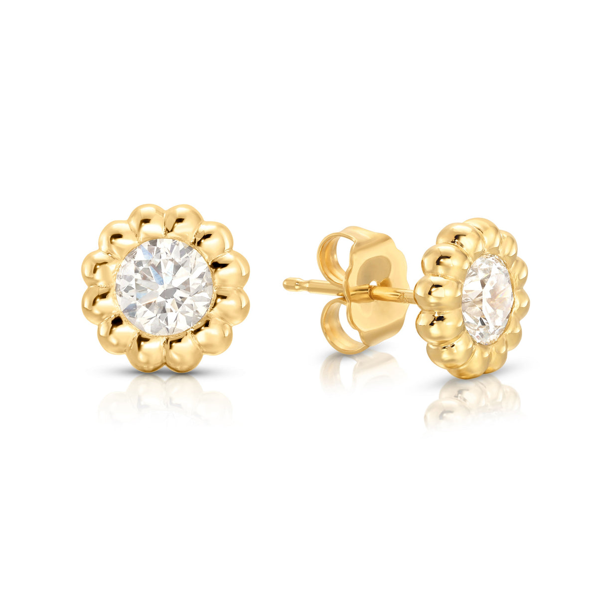 Front and side view of Reverie diamond stud earrings with 1 ct round diamonds in fluted 14K yellow gold bezels