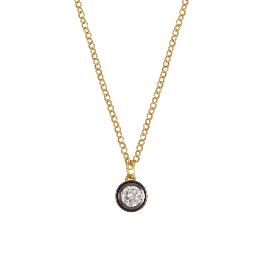 Front view of Rhodium Bezel Charm Necklace showcasing a round bezel-set charm with a clear stone on a white background
