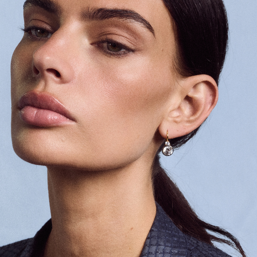 Close-up side view of Rhodium Double Bezel Drop Earrings showcasing the dangling double bezel design against a neutral background