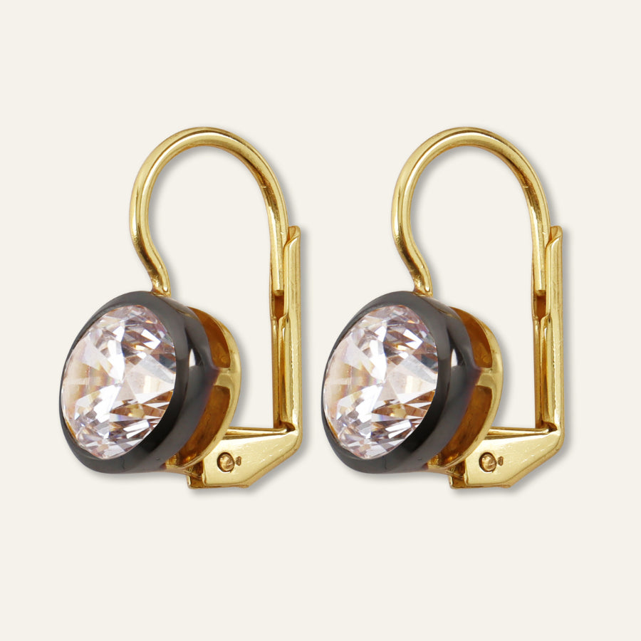 Front view of Rhodium Oval Bezel Drop Earrings with oval cubic zirconia stones and dark rhodium bezels on a light background