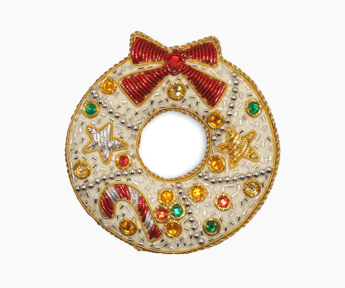 Front view of Ribbon Wreath Ornament showcasing hand stitched beads and metallic thread on velveteen fabric with a white background