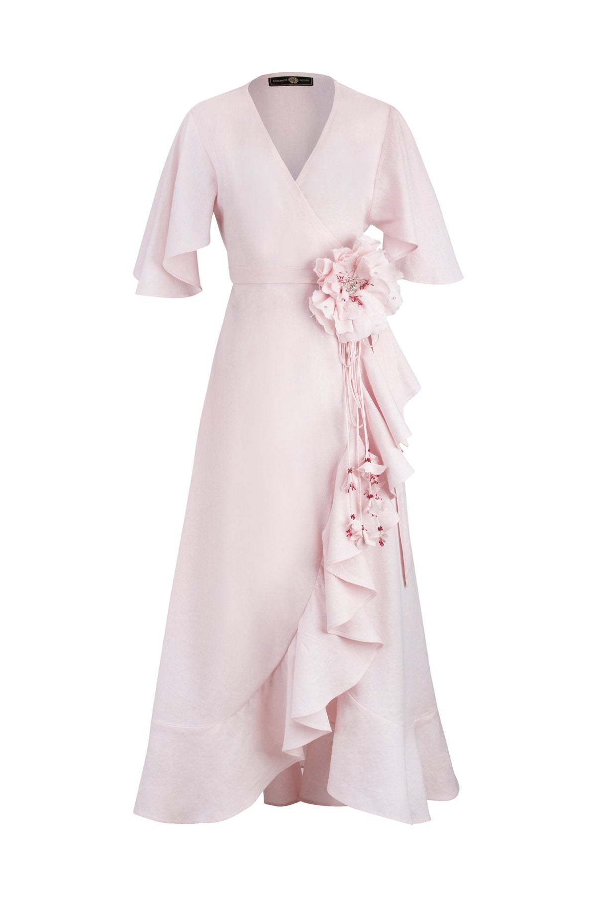 Front view of Gol Wrap Dress in Pink showcasing a handmade flower with handmade petals and butterfly sleeves on white