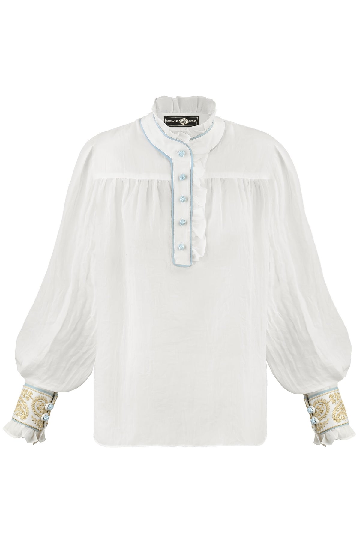 Front view of Cypress Blouse in white showing ruffled collar, blue-piped silk button placket, billowy sleeves, and embroidered gold cuffs