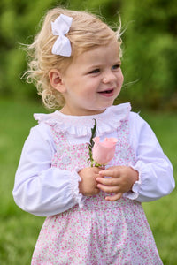 Little English traditional children's clothing.  Light pink and green floral overall with ruffle detailing layered over white knit smocked Madeline Blouse in light pink