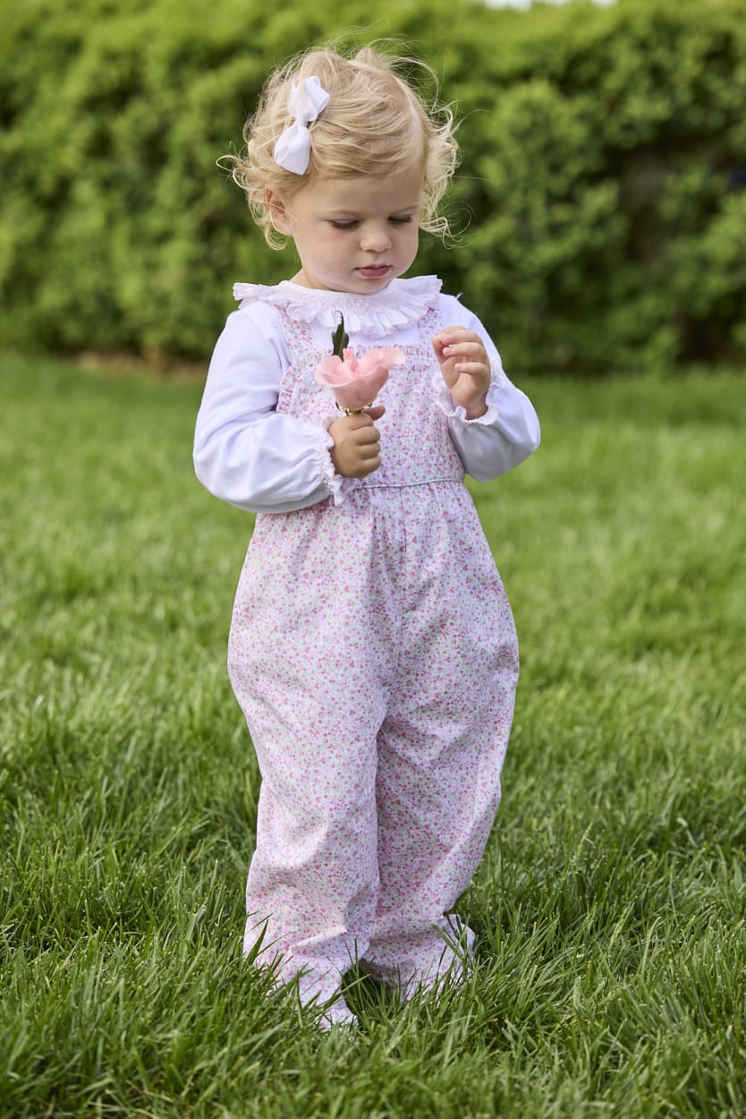 Little English traditional children's clothing.  Light pink and green floral overall with ruffle detailing layered over white knit smocked Madeline Blouse in light pink