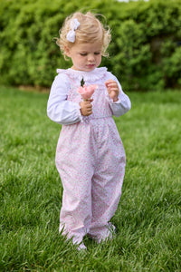 Little English traditional children's clothing.  Light pink and green floral overall with ruffle detailing layered over white knit smocked Madeline Blouse in light pink