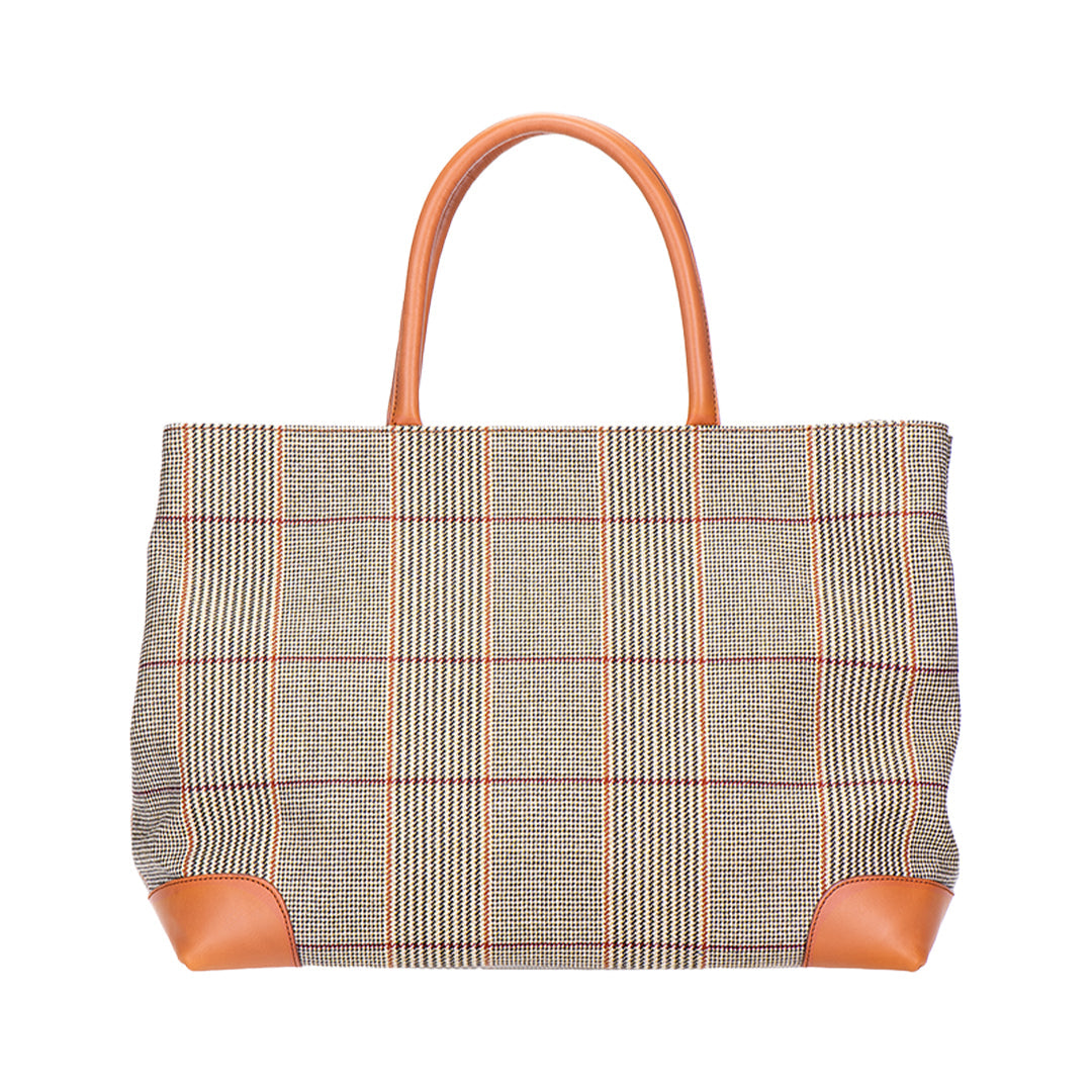 Front view of Russell Tweed Tote showcasing the tweed exterior, leather handles, and leather corner accents against a white background